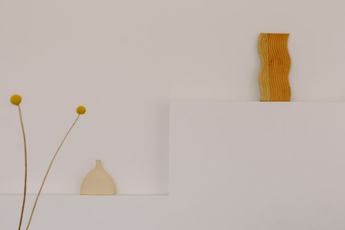 Free Simple and elegant minimalist decor featuring a wooden sculpture and vase. Stock Photo