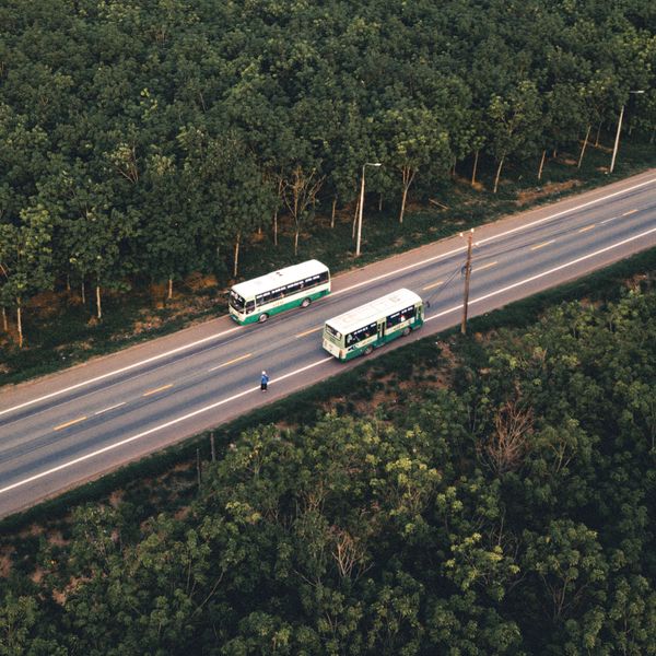 Coach shuttle on a coastal road — photo by Nguyen Van Quy Ngoc on Pexels