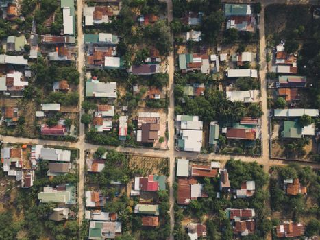 Aerial photo capturing the dense residential blocks and green trees in Ho Chi Minh City, Vietnam.