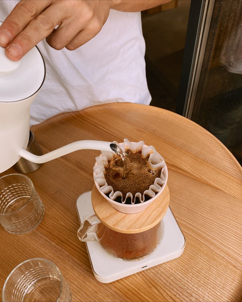 A pour-over brewing on a wooden bar — photo by Valeriya Kobzar on Pexels