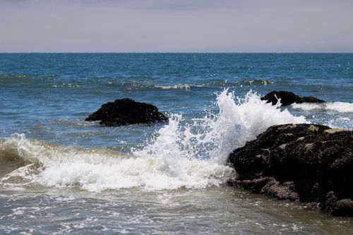 Free Photograph of powerful ocean waves crashing against rocky formations in Carpinteria, California. Stock Photo