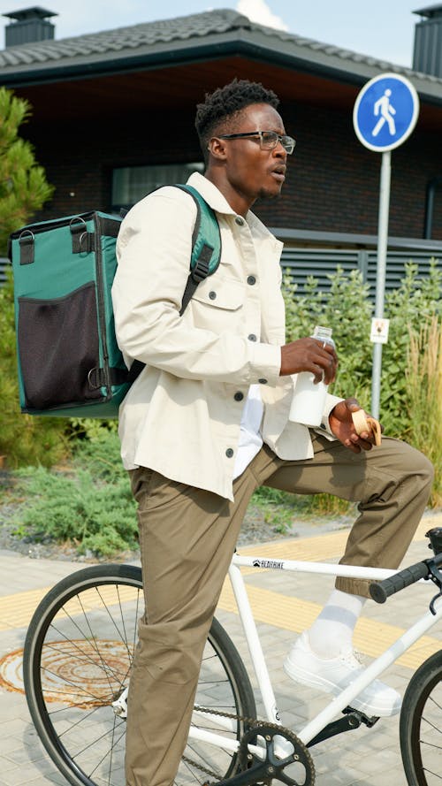 Photo of a Deliveryman on a Bike, Drinking Milk