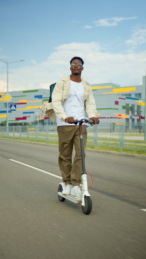 Man Riding a Electric Scooter on the Road