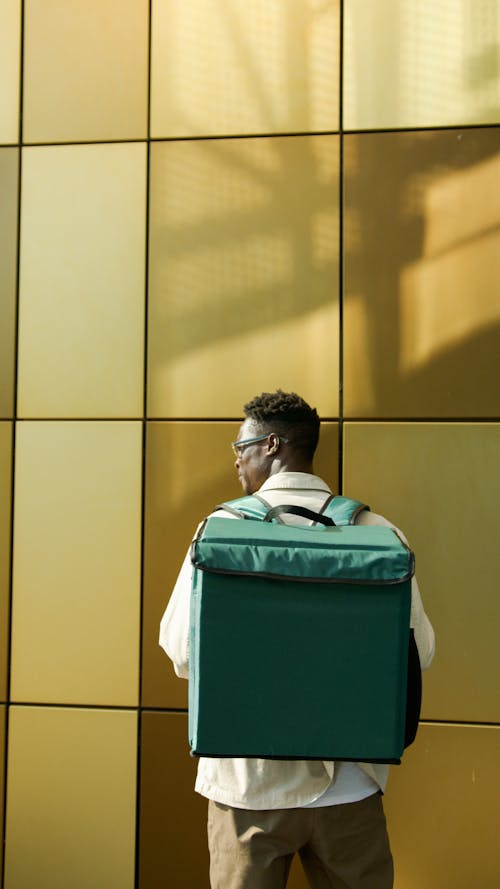 Back View of a Deliveryman with a Backpack