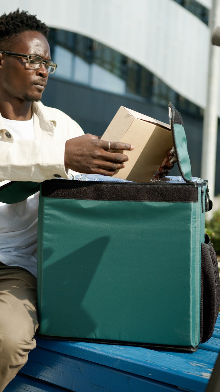 A Man Checking A Package