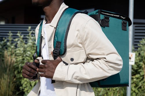 A Close-Up Shot of a Man Wearing a Backpack
