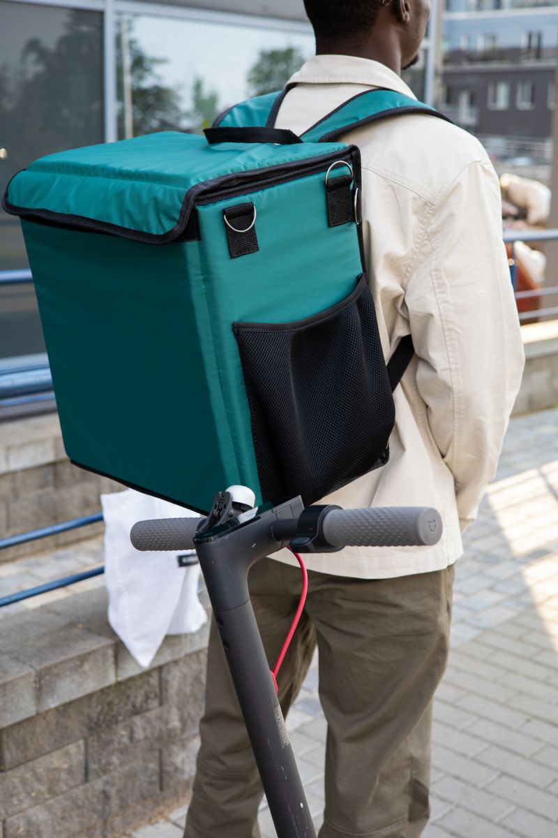 Delivery rider with teal backpack — photo: Artem Podrez on Pexels
