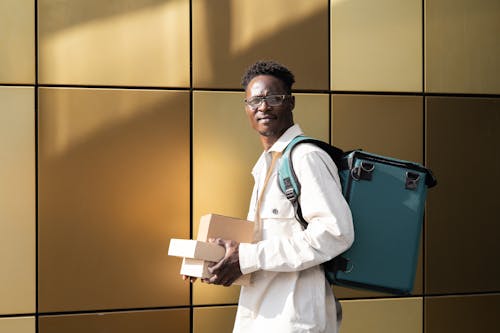 Free Man in White Dress Shirt Carrying a Thermal Bag and Packages Stock Photo