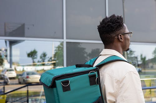 A Close-Up Shot of a Man Wearing a Backpack