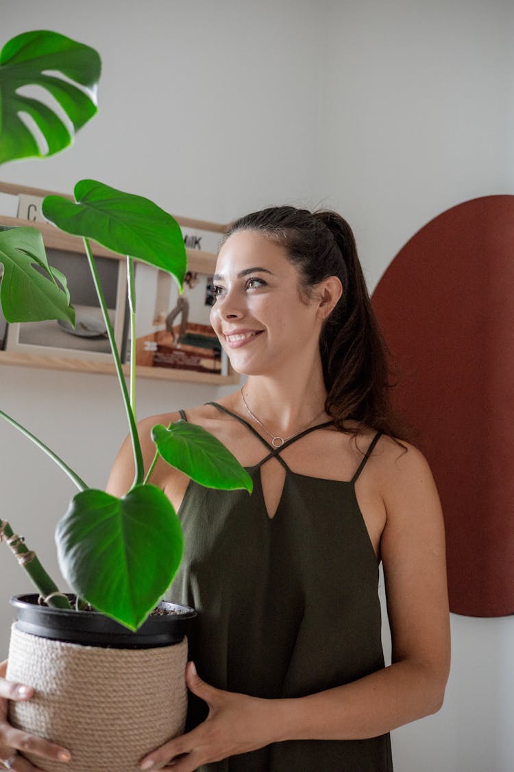 Woman Holding A Plant On A Pot