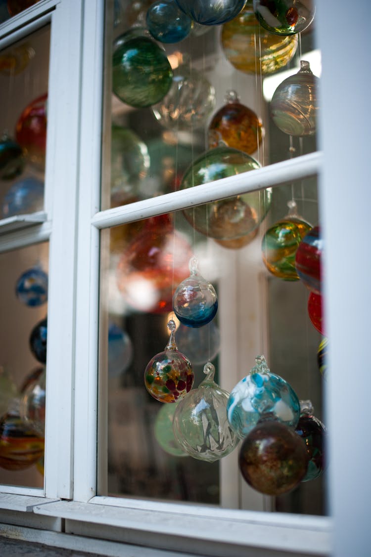 Assorted Glass Baubles Hanging By The Window