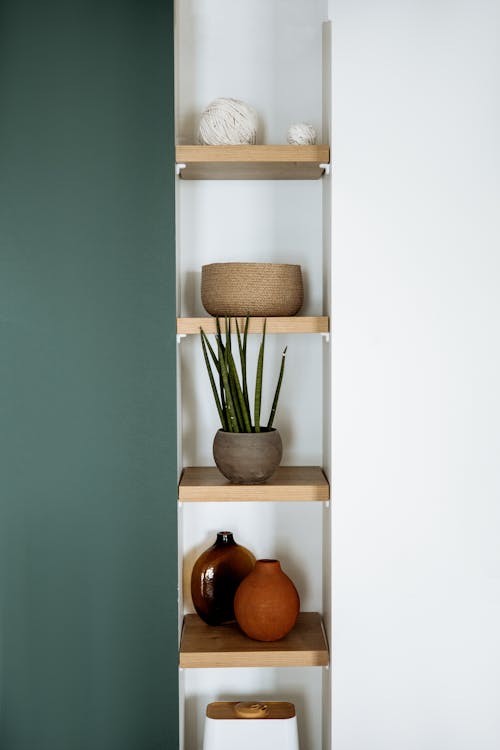 Free Brown Wooden Shelves With Vases Stock Photo