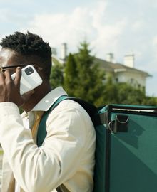 Field courier checking a delivery on a mobile phone