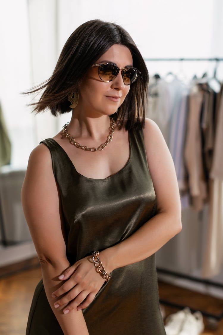 A Woman In Sleeveless Dress Waring A Sunglasses