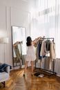 Woman in White Dress Standing in Front of Mirror