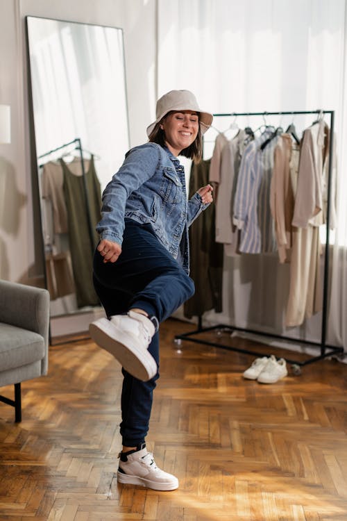 Free A Woman in a Bucket Hat and Denim Jacket Doing a Kick Stock Photo