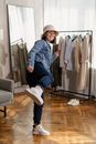 A Woman in a Bucket Hat and Denim Jacket Doing a Kick