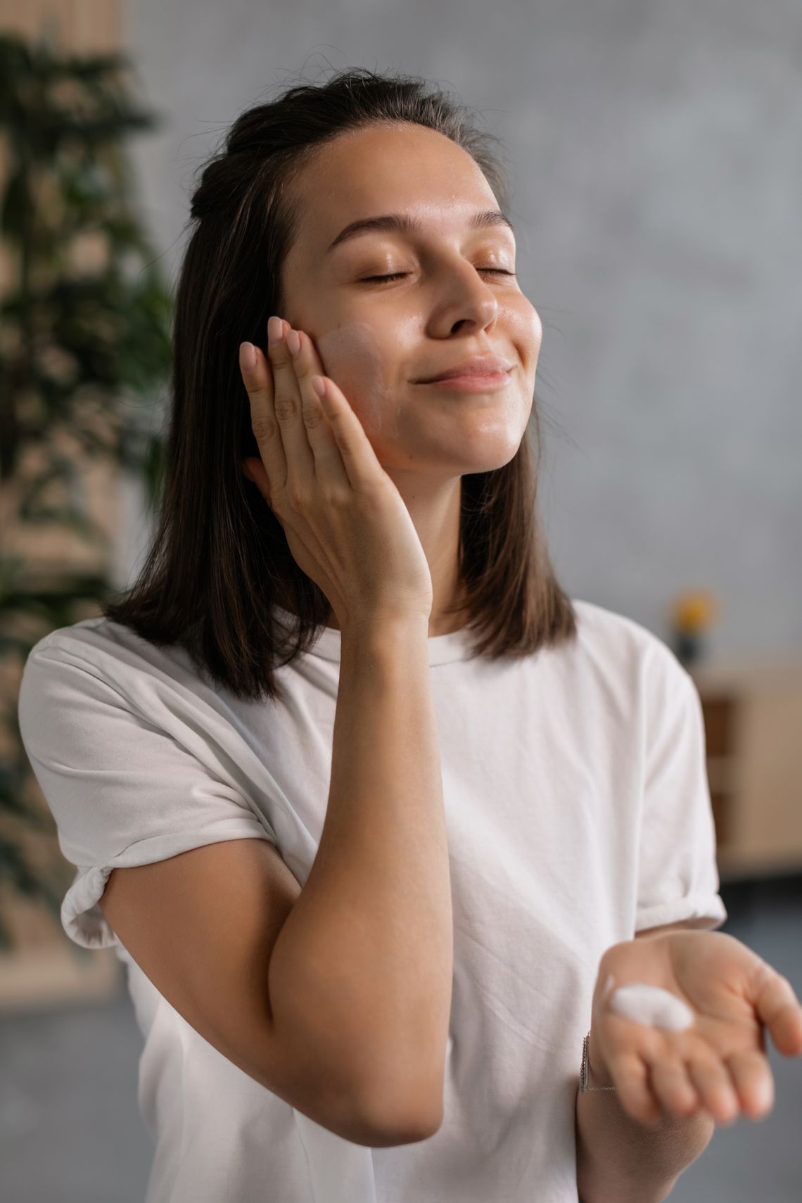 Woman applying facial cream as part of a gentle skincare routine