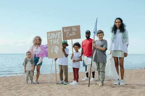Free Environmentalists Standing Together at a Beach Stock Photo