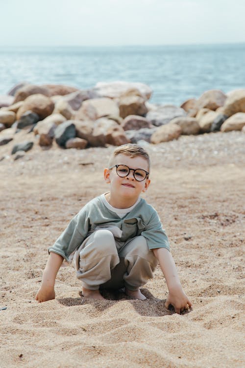A Boy Playing on the Beach Sand