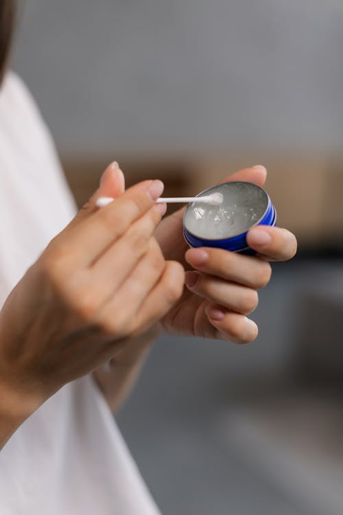 Close-Up Shot of a Person Holding a Cotton Swab