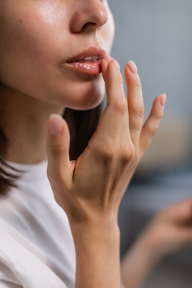 Woman In White Crew Neck Shirt Touching Lower Lips