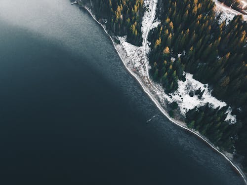 Aerial View of a River Beside a Snow Covered Forest in Perm, Russia