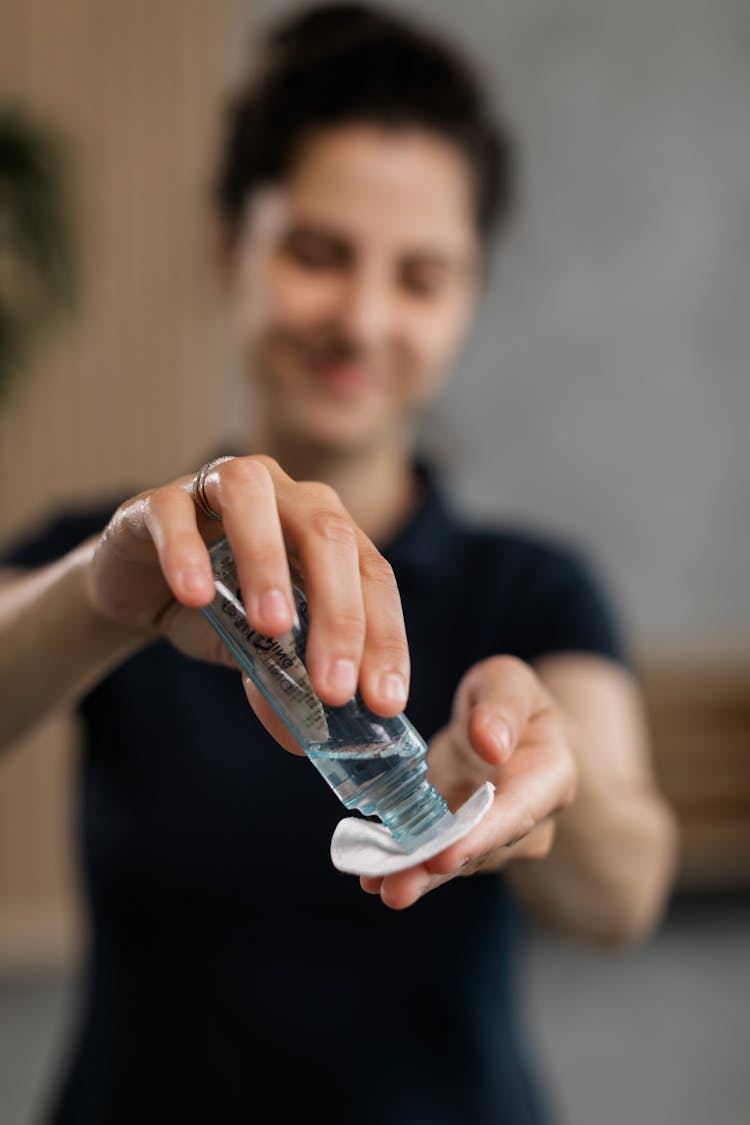 A Woman In Black Shirt Pouring Toner On A Cotton