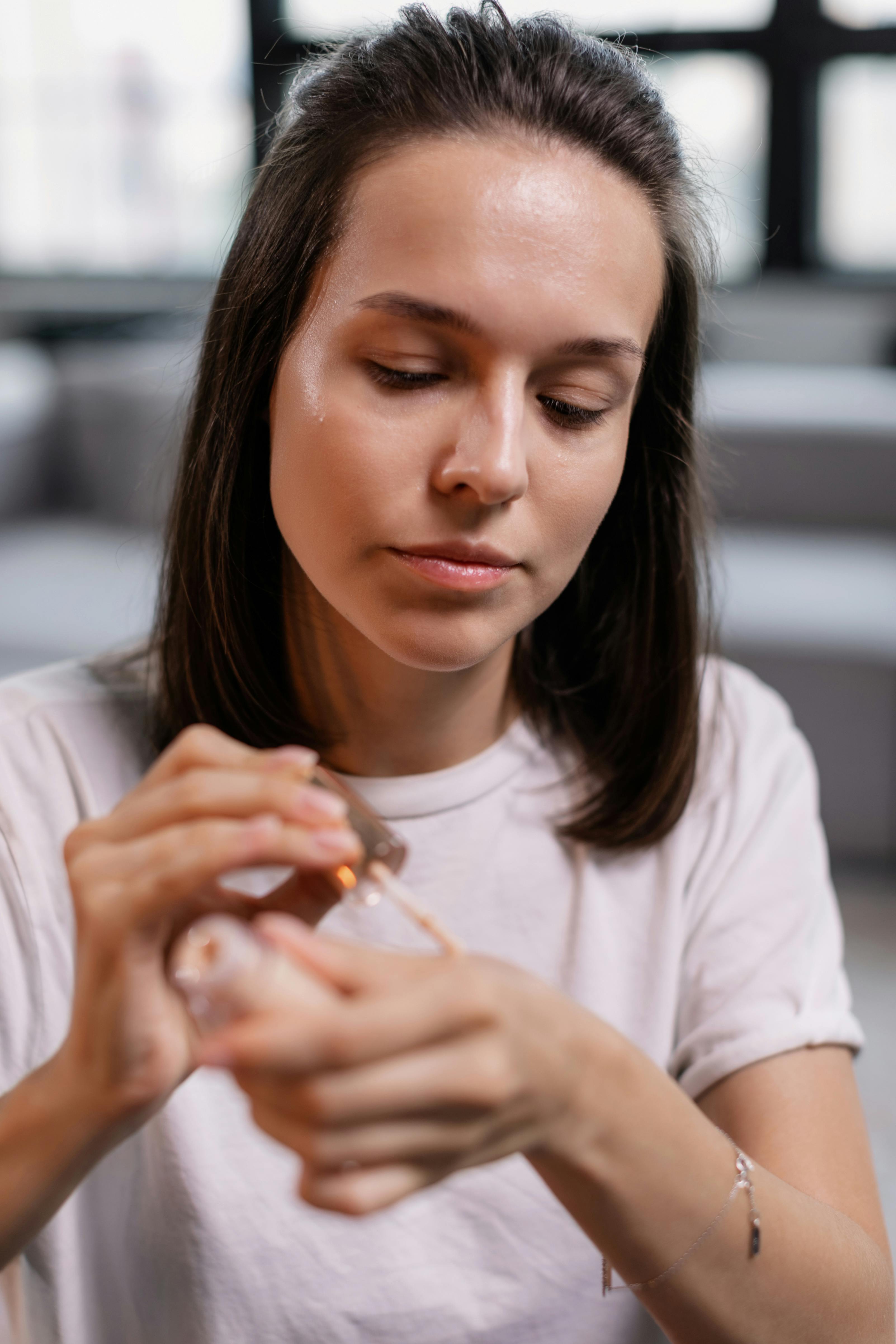 a woman using a liquid makeup