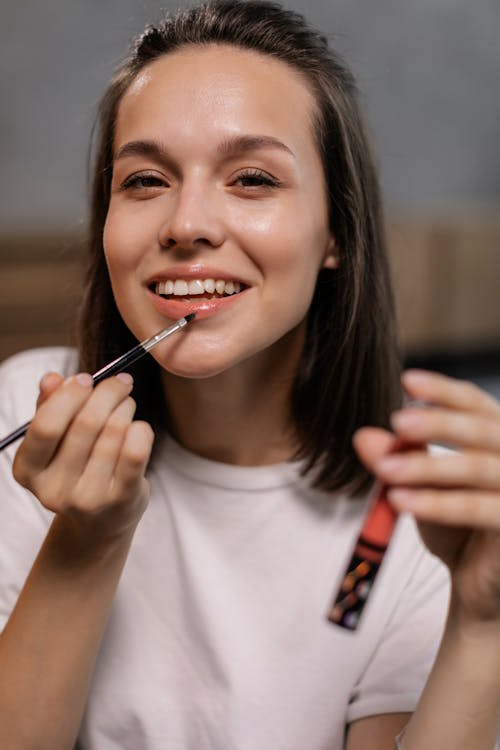 Pretty Woman Applying Lipstick 