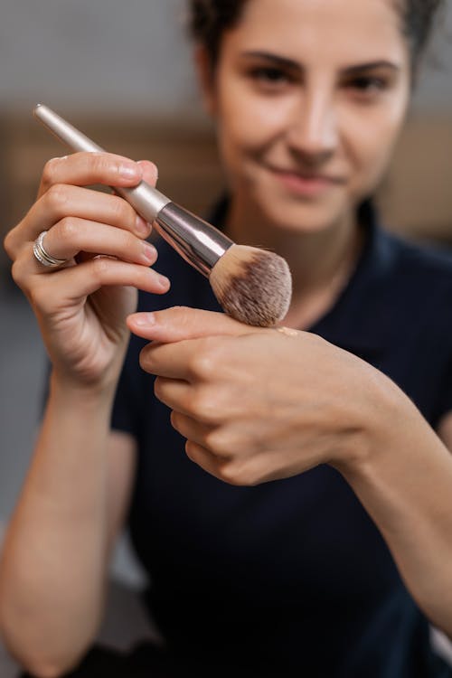 Woman Holding Makeup Brush