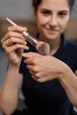 Man in Black Crew Neck Shirt Holding Silver Makeup Brush