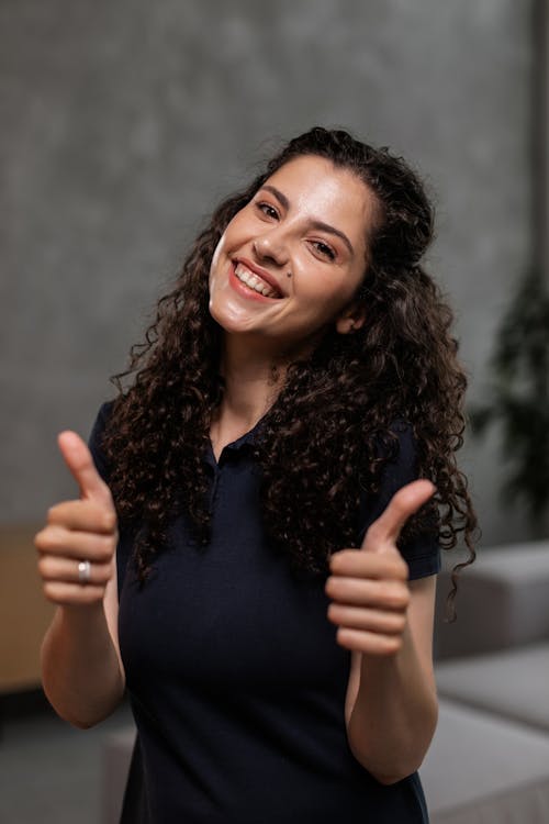Free Curly Haired Woman with her Thumbs-up Stock Photo