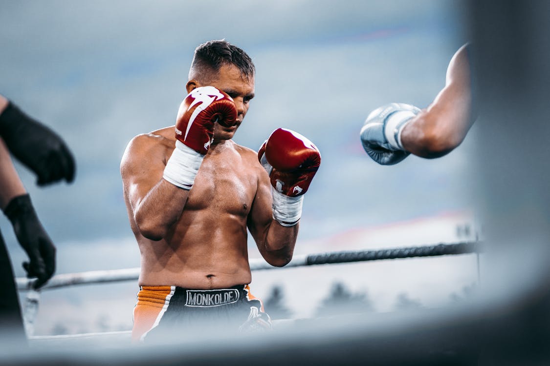 Free A Man in Red Boxing Gloves Stock Photo