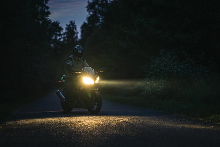 Man On Motorcycle On Road At Night