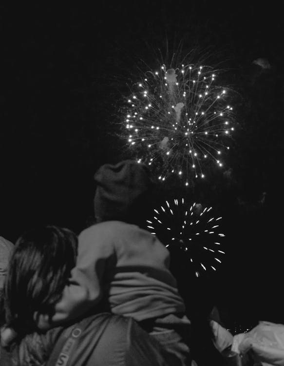 Free People Looking at Fireworks in the Sky Stock Photo