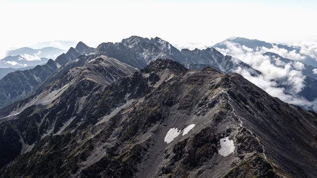 Breathtaking aerial view of the rugged Japanese mountain landscape under a cloudy sky.