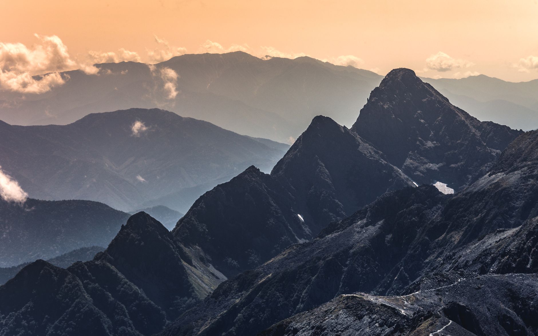 Stunning mountain range with dramatic peaks at sunrise in Japan, capturing the serene beauty of nature.