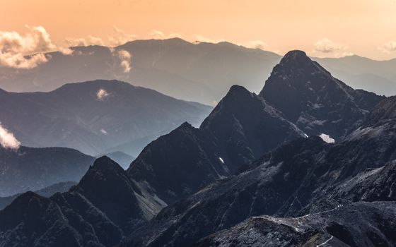 Stunning mountain range with dramatic peaks at sunrise in Japan, capturing the serene beauty of nature.