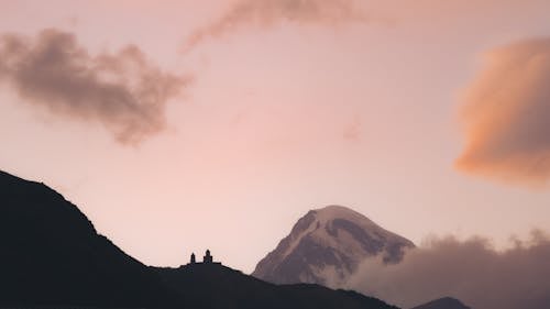 Free Silhouette of Chapel on Mountain During Sunrise Stock Photo