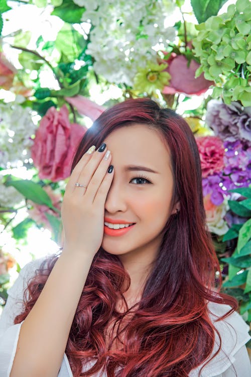 Woman in White Blouse Covering Her Eye