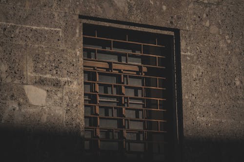 Brown Metal Window Frame on Gray Concrete Wall