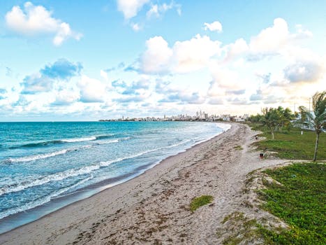 A serene view of Intermares beach in Brazil with waves and clear blue sky.