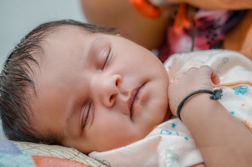 Free Selective Focus Photo of a Cute Newborn Sleeping Stock Photo
