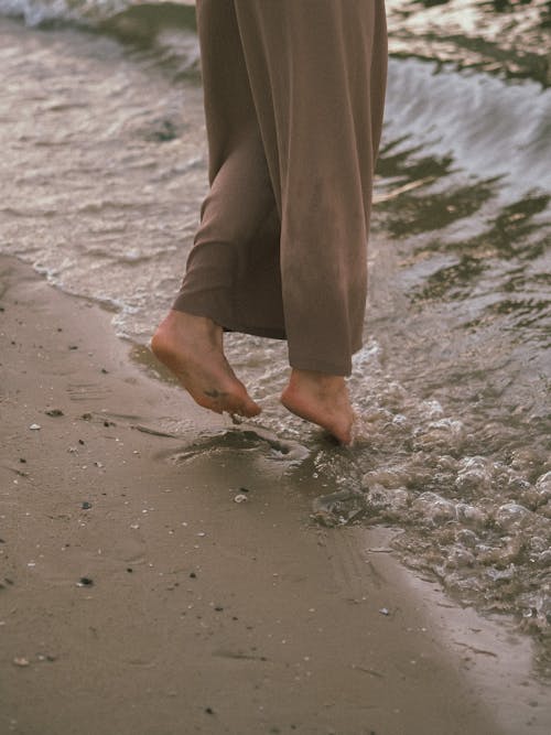 Free  Person Standing on the Seashore Stock Photo