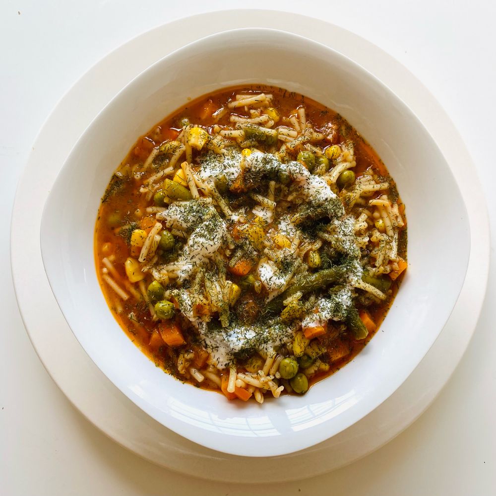 Warm vegetable soup in a bowl viewed from above