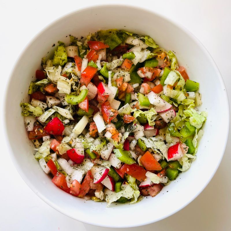 Overhead chopped salad in a white bowl — I Own My Food Art on Pexels