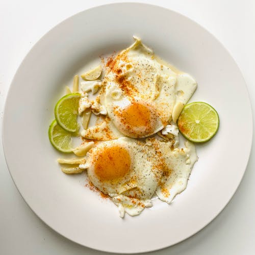 Free Fried Eggs on White Ceramic Plate Stock Photo