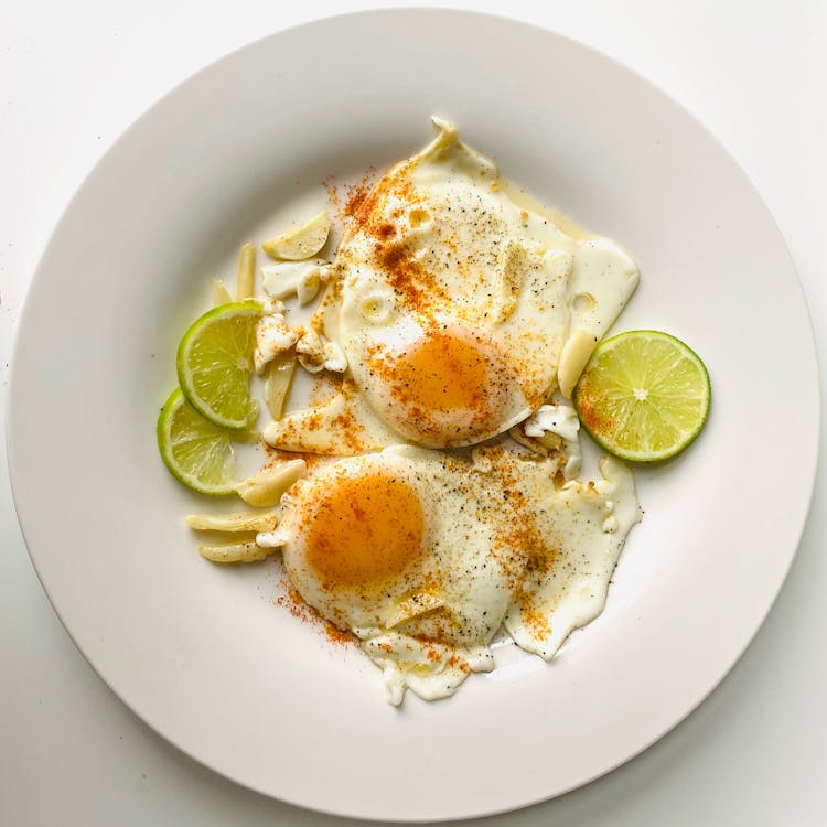 Fried Eggs On White Ceramic Plate