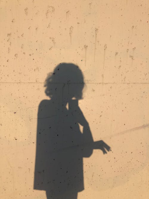Photo of a Person's Shadow on a White Wall